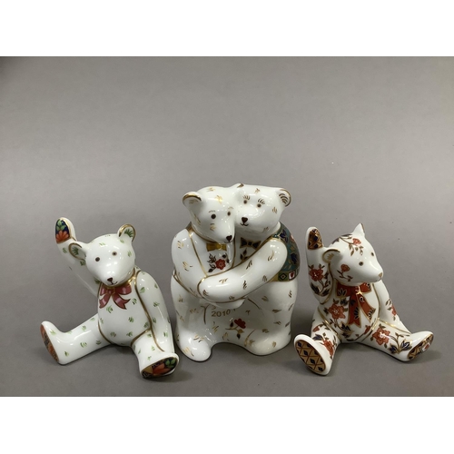 35 - A group of Royal Crown Derby teddy bears including two bears hugging with year 2010 and two seated b... 