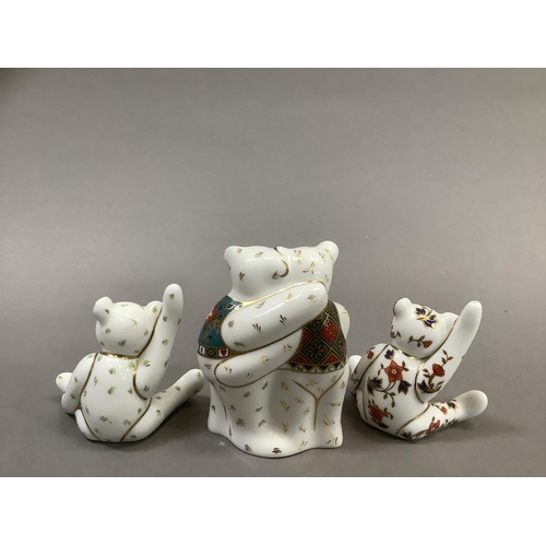 35 - A group of Royal Crown Derby teddy bears including two bears hugging with year 2010 and two seated b... 