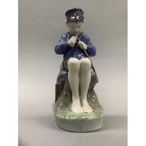 37 - A Royal Copenhagen figure of a Dutch boy whittling a stick, 18.5cm high