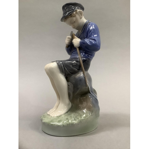 37 - A Royal Copenhagen figure of a Dutch boy whittling a stick, 18.5cm high