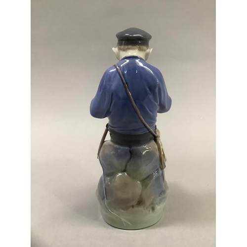 37 - A Royal Copenhagen figure of a Dutch boy whittling a stick, 18.5cm high