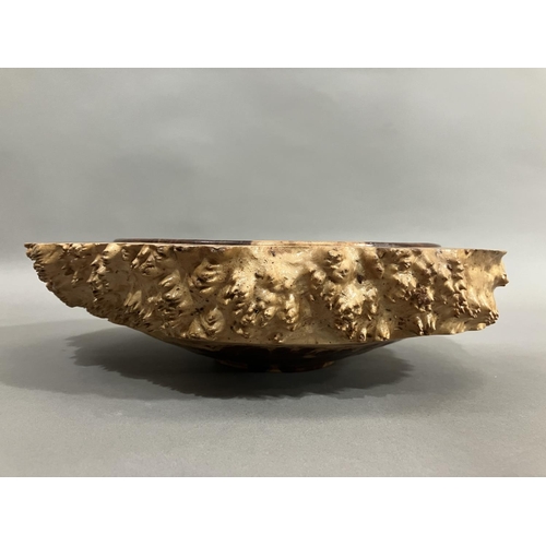 47 - A turned walnut fruitbowl, the exterior formed as bark with a smooth interior