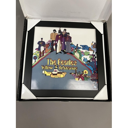 48 - A Coalport Characters Beatles Yellow Submarine plaque, together with a Mad Day Out photoshoot book b... 