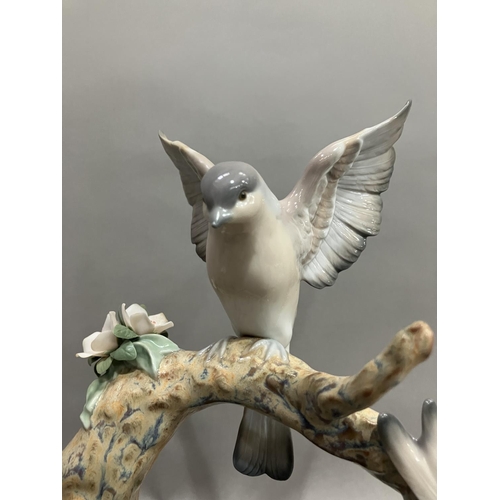 50 - A Lladro figure group, Forest Song, Utopia series depicting birds on a two limbed branch with cluste... 