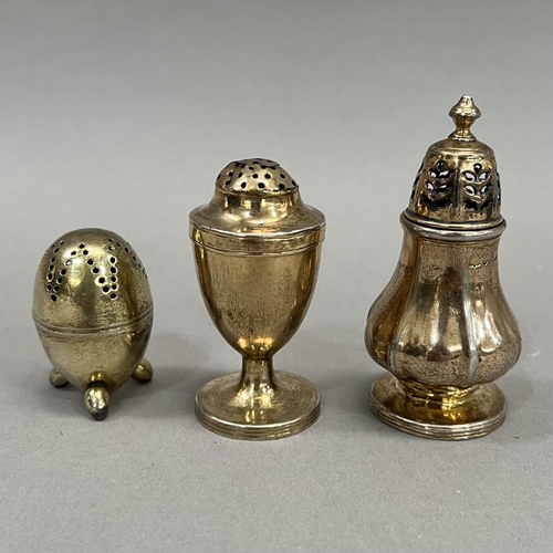 396 - A George III silver gilt pepper pot, London 1792 for William Schofield, of bombé shape on three bull... 