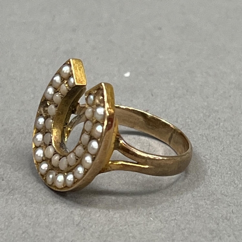 444 - An early 20th century coral and seed pearl set horse shoe ring in 9ct gold (at fault), two pearls mi... 