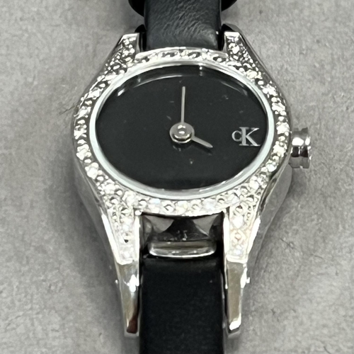 428 - A Calvin Klein lady’s quartz wrist watch in a diamond set stainless steel case, no. K2723 00, black ... 