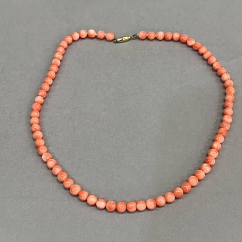 465 - A necklace of spherical coral beads, each approximate 6mm diameter fastened with 9ct gold snap, appr... 