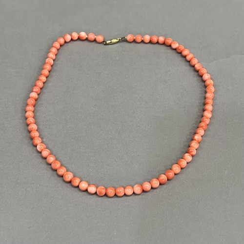 465 - A necklace of spherical coral beads, each approximate 6mm diameter fastened with 9ct gold snap, appr... 