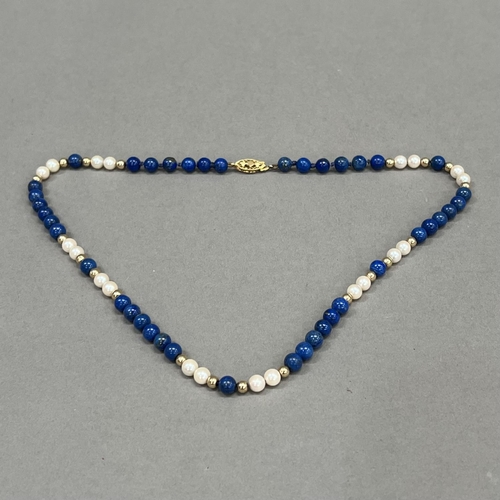 463 - A necklace of spherical 6mm diameter Lapis Lazuli beads, 5.5mm diameter cultured pearls and 4mm diam... 