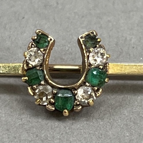 429 - A Victorian Demantoid garnet and diamond horseshoe stock pin in 15ct gold, on a 9ct rose gold pin, a... 