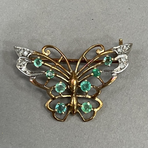 453 - An emerald and diamond butterfly brooch in 9ct gold, claw and grain set with graduated circular face... 