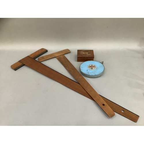 106 - Two T- squares and a mid 20th century Rabone Chesterman tape measure and a box set of scales by J W ... 