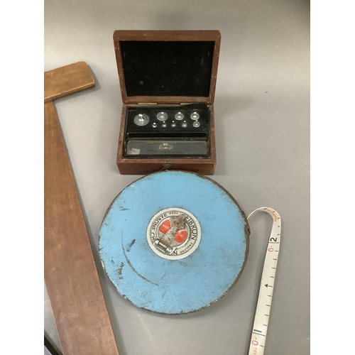 106 - Two T- squares and a mid 20th century Rabone Chesterman tape measure and a box set of scales by J W ... 