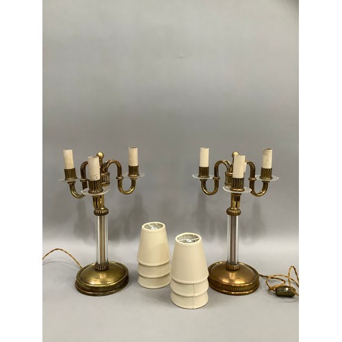 126 - A pair of continental Art Deco brass and glass three light table lamps the serpentine arms with reed... 