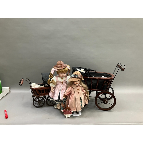 354 - Two modern ceramic dolls with jointed bodies and Victorian style pram together with another smaller ... 