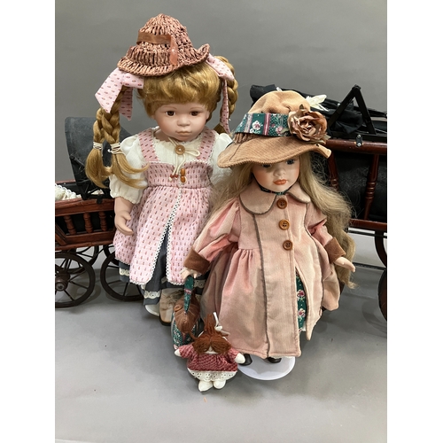 354 - Two modern ceramic dolls with jointed bodies and Victorian style pram together with another smaller ... 