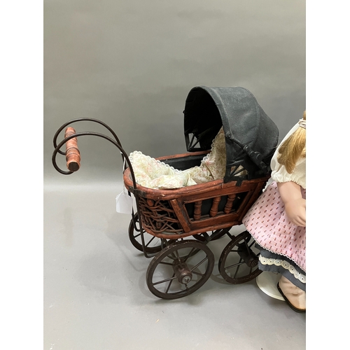 354 - Two modern ceramic dolls with jointed bodies and Victorian style pram together with another smaller ... 