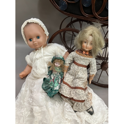 352 - Two dolls with porcelain heads and limbs, jointed bodies and together with a modern realistic doll i... 