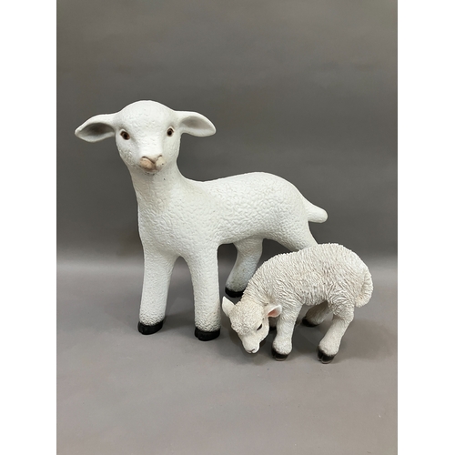 129 - A ceramic figure of a lamb together with a smaller composite example