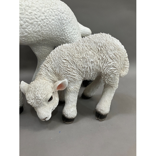 129 - A ceramic figure of a lamb together with a smaller composite example