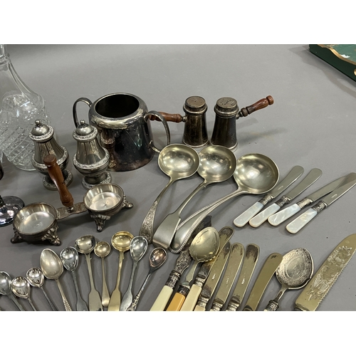 307 - A collection of silver plated ware and glass ware comprising two decanters with stoppers, salt and p... 