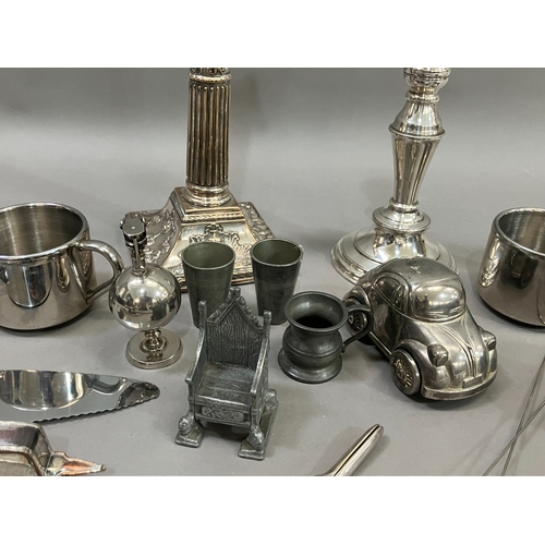 307 - A collection of silver plated ware and glass ware comprising two decanters with stoppers, salt and p... 