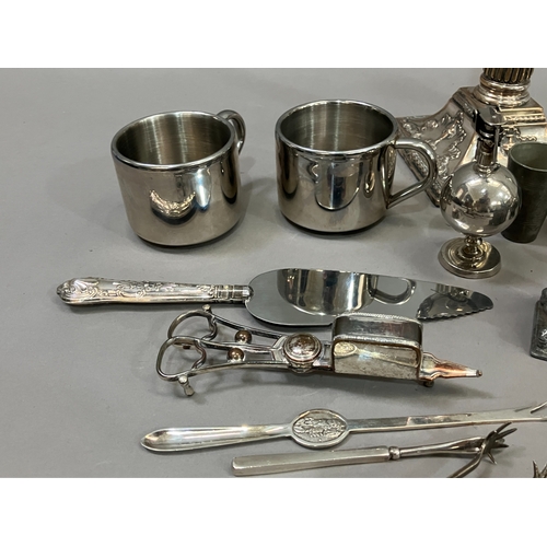 307 - A collection of silver plated ware and glass ware comprising two decanters with stoppers, salt and p... 