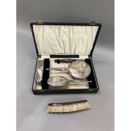 399 - Four piece silver backed dressing table set, Birmingham 1932 in fitted case, comprising hand mirror,... 