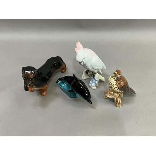 234 - A Beswick thrush model 2308, a Poole pottery Dolphin, a Beswick Dachshund and a Czechoslovakian cock... 