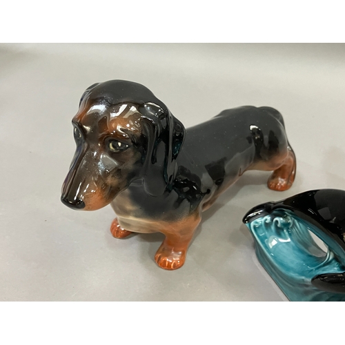 234 - A Beswick thrush model 2308, a Poole pottery Dolphin, a Beswick Dachshund and a Czechoslovakian cock... 