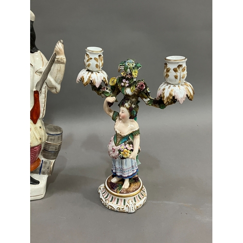 254 - A 19th century German china two light candelabra raised on a female figure with flowers and grapes, ... 