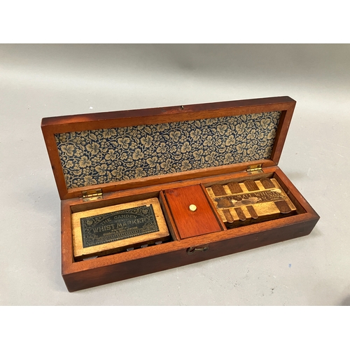 88 - An early 20th century games box with inlaid cover, interior with four whist markers together with a ... 