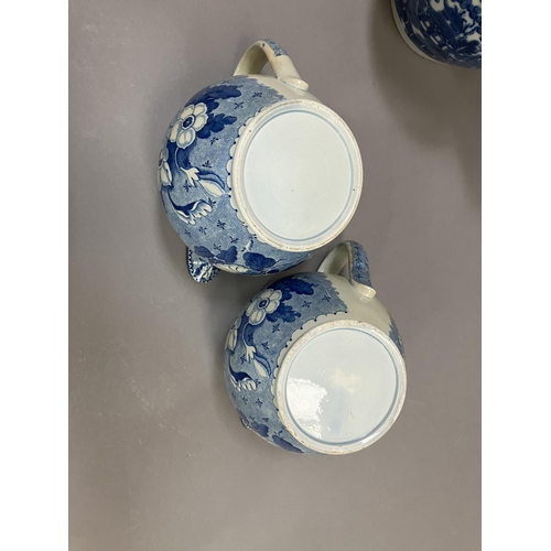 264 - A pair of 19th century blue and white transfer printed jugs of floral pattern, 14cm over handle toge... 