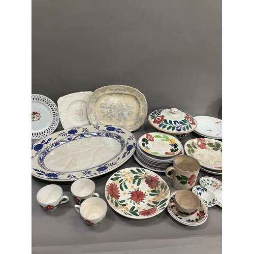 114 - A part pottery service painted with stylised flowers including tureen, plates in different sizes, tr... 