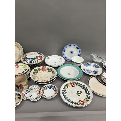 114 - A part pottery service painted with stylised flowers including tureen, plates in different sizes, tr... 