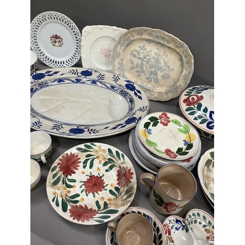 114 - A part pottery service painted with stylised flowers including tureen, plates in different sizes, tr... 