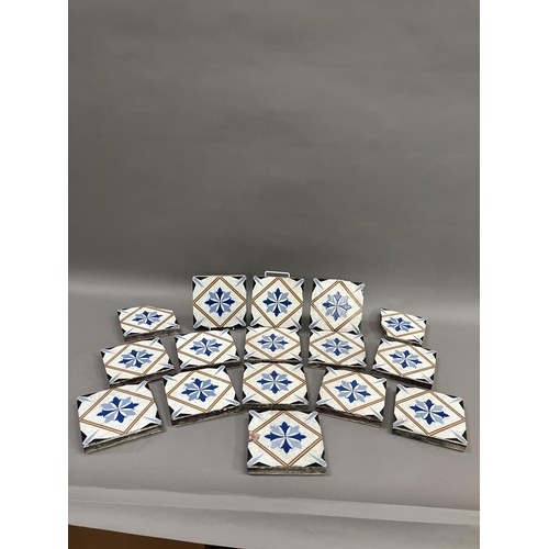 483 - A set of thirteen 19th century Minton tiles glazed in white with a two-shade blue stylised flower to... 