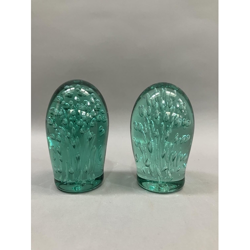 58 - Two Victorian green glass dumps having air bubble inclusions, largest example 15cm high