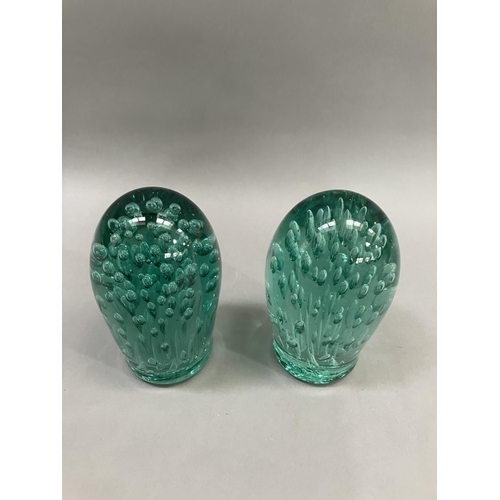 58 - Two Victorian green glass dumps having air bubble inclusions, largest example 15cm high