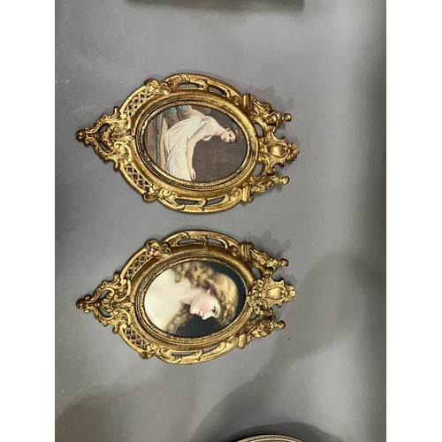 64 - A pair of gilt metal wall hanging picture frames having pierced and moulded decoration, the pediment... 