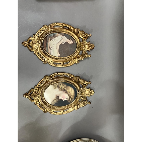 64 - A pair of gilt metal wall hanging picture frames having pierced and moulded decoration, the pediment... 