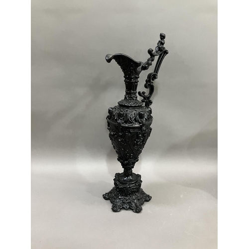 65 - A French black cast metal and heavily moulded ewer, the handle surmounted by cherub, 45cm high