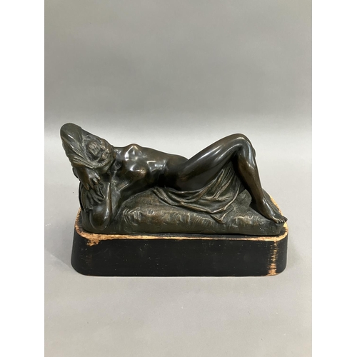 69 - A cast bronze model of a nude woman reclining, indistinctly signed on base 26cm long