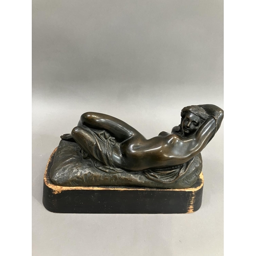 69 - A cast bronze model of a nude woman reclining, indistinctly signed on base 26cm long