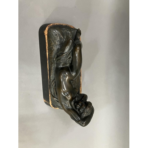 69 - A cast bronze model of a nude woman reclining, indistinctly signed on base 26cm long