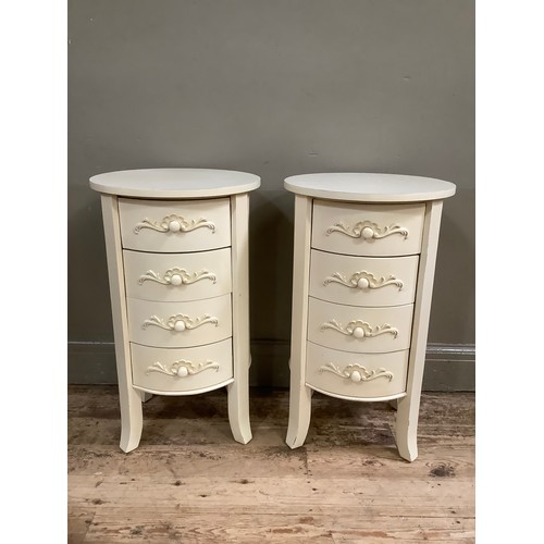 142 - A pair of French style cream painted bedside drawers with circular tops and having four drawers