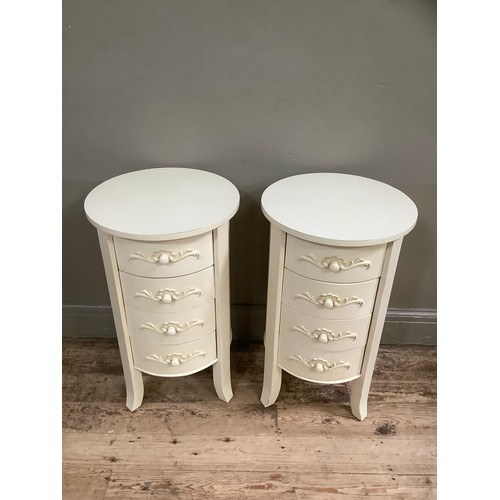 142 - A pair of French style cream painted bedside drawers with circular tops and having four drawers