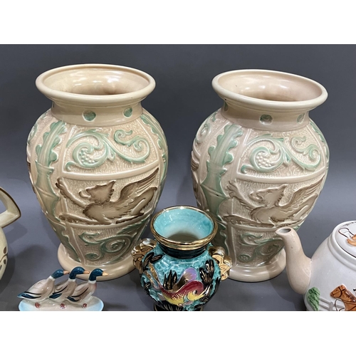 299 - A pair of Burleigh ware Art Deco vases moulded in relief with winged animals and foliage in green an... 