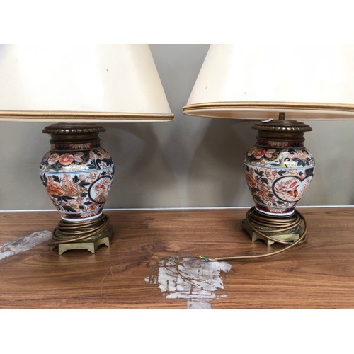 311 - A pair of gilt metal mounted Imari vase shaped table lamp of globular form painted in under glaze bl... 